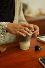 A Cup of milkshake topping white black sesame on the wood table