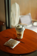 A cup of ice amaricano and bakery on the wood table