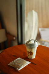 A Cup of milkshake topping white black sesame on the wood table