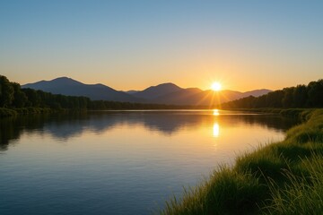 Sunrise over a river with a bright yellow sun rising above distant blue mountains and a clear sky