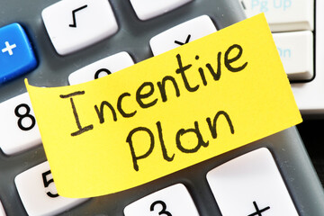 Sticker with words Incentive plan on the calculator
