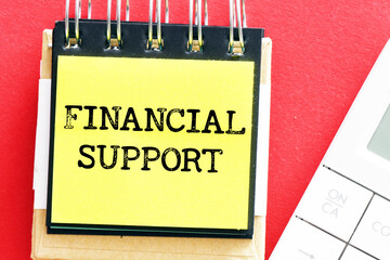 FINANCIAL SUPPORT words in a small office notebook.