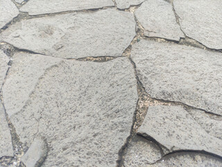 Gray flagstone, featuring irregularly shaped stones. Ideal for backdrops and wallpaper.