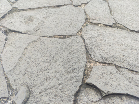Gray flagstone, featuring irregularly shaped stones. Ideal for backdrops and wallpaper.