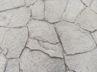 Gray flagstone, featuring irregularly shaped stones. Ideal for backdrops and wallpaper.