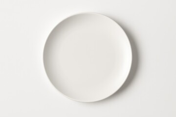 White ceramic plate on a white background, viewed from above