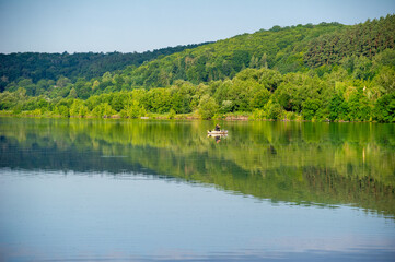 Fototapeta premium reflection of trees in the water of lake in the mountains