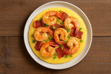 Fresh shrimp and bacon served on a wooden platter with grits and green onions