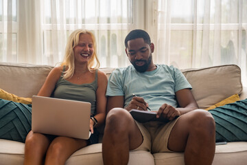 Two young people, couple in relationship, working together at home office. Startup new global...