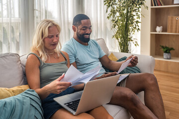 Two young people, couple in relationship, working together at home office. Startup new global...