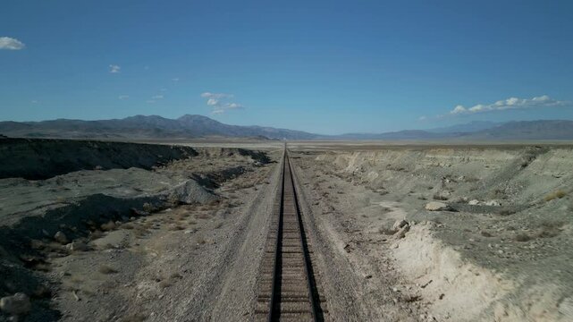 A view over desert train tracks leading to Trona, California