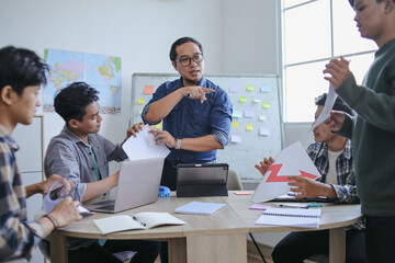 Male Teacher In Glasses Guiding Students Through Data Driven Presentation