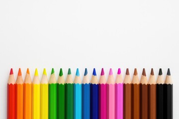 Line of colored pencils arranged on a plain white surface