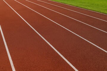 Outdoor athletic lane with textured rubber surface pattern