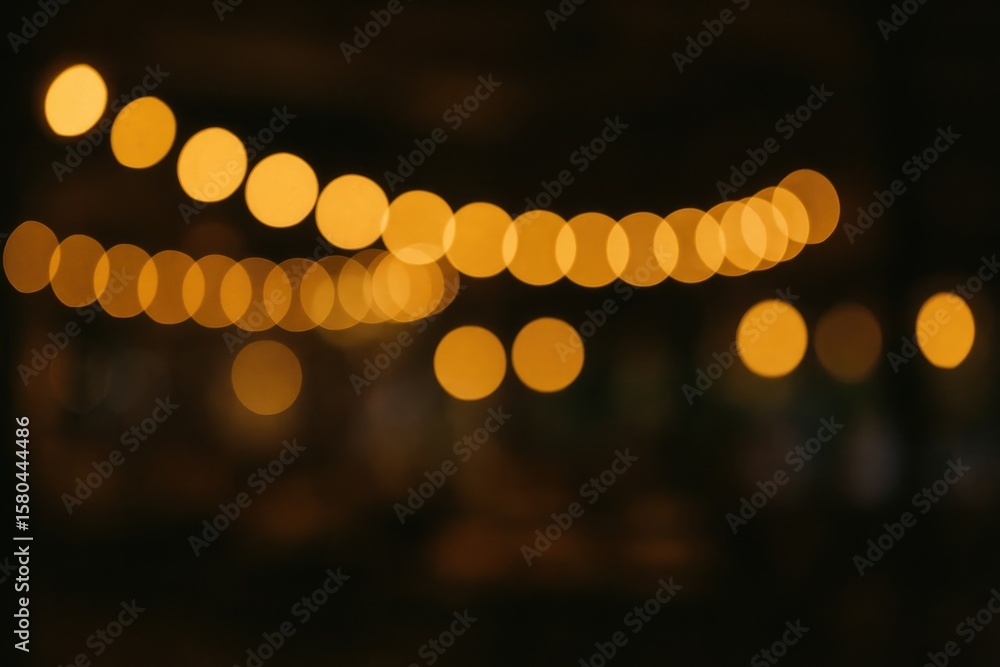 Poster an abstract shot of a restaurant illuminated by a string of lights with a soft, noisy background