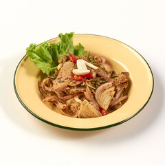 Spicy stir fried pork with onions, garlic, and chili served in yellow enamel bowl, garnished with fresh lettuce and herbs for flavorful presentation