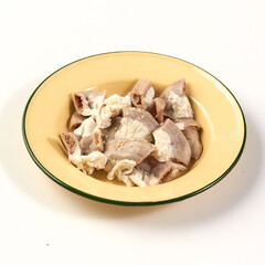 Boiled pork intestines served in yellow enamel bowl, showcasing traditional dish with chewy texture and savory flavor, often used in Asian cuisine