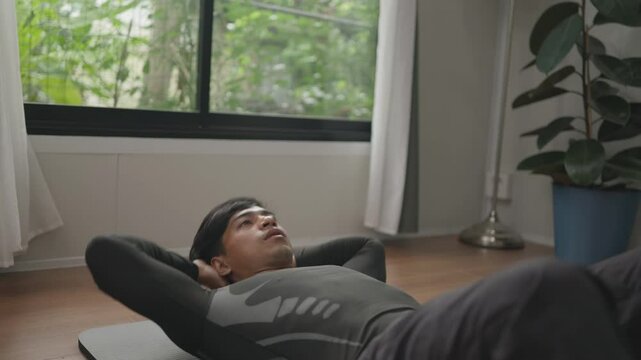 Asian male exercising abs indoors.4k