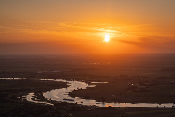 sunset over bend in Dutch river Ijssel romantic evening in the Netherlands. flat scenery in the province of Utrecht
