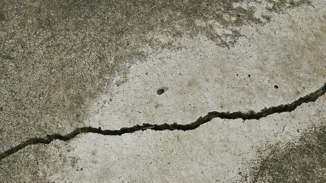 Old concrete wall texture large crack and dirty wall surface with large damage.