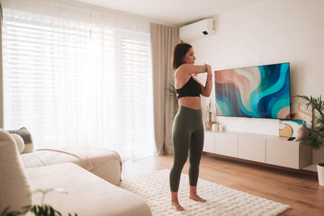 Home Workout Routine A Young Woman Stretching Gracefully in Her Modern Living Room Space