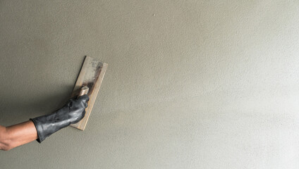 Cement wall, Hand worker Plastering wet Cement Background with handle brush trowel, Manual men handwork polish concrete floor rough texture decorated loft surface well free space for text presentation