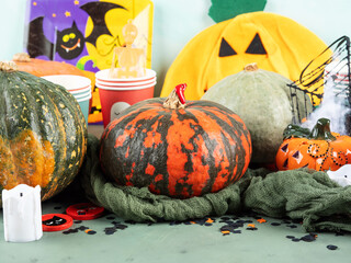 Halloween party setting with pumpkins, candies and decor