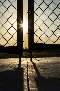 Sunset through silhouetted gates