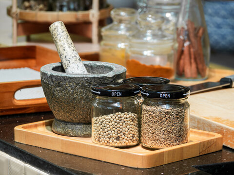 Traditional Mortar and Spice Jars in a Rustic Kitchen Setting
