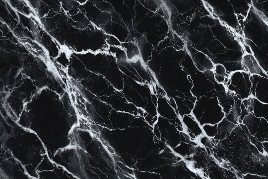 Glossy black marble texture with dramatic white veining.