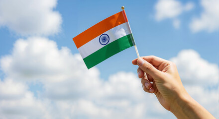 Hand Holding Pakistan National Flag Against Clear Blue Sky