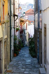 Fototapete Narrow Streets of Ribeira Old Town in Porto, Portugal. Charming narrow streets of Porto’s Ribeira old town with colorful facades, historic atmosphere, and authentic Portuguese urban life. © Uladzimir
