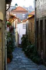  Narrow Streets of Ribeira Old Town in Porto, Portugal. Charming narrow streets of Porto’s Ribeira old town with colorful facades, historic atmosphere, and authentic Portuguese urban life. © Uladzimir