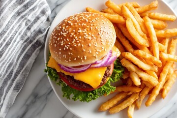 Top down shot of a classic cheeseburger with fries on a white plate for food photography.