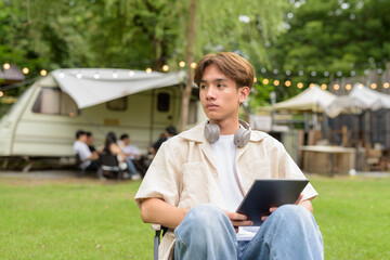 Young non binary person having road trip and camping with friends in nature