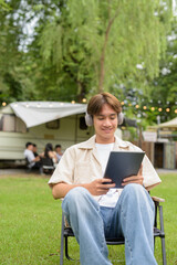 Young non binary person having road trip and camping with friends in nature
