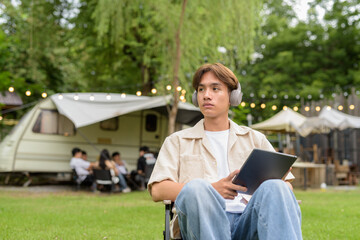 Young non binary person having road trip and camping with friends in nature