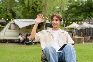 Young non binary person having road trip and camping with friends in nature
