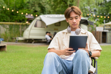 Young non binary person having road trip and camping with friends in nature