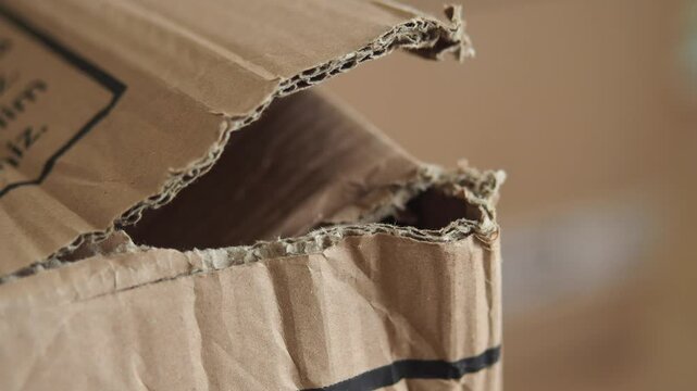Delivery location has a damaged cardboard box