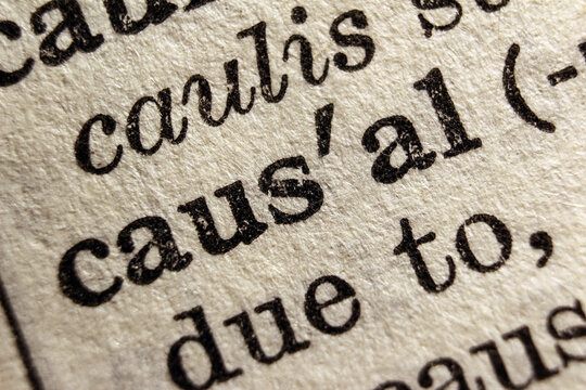 Word causal on dictionary page, macro close-up	
