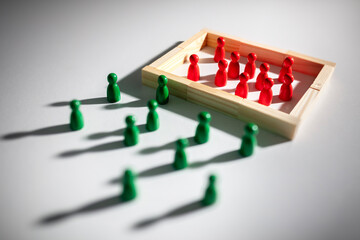 Racism or segregation, crowd of red wooden people separated behind a wall