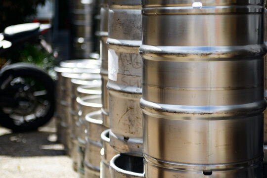 Metal beer kegs stacked in rows