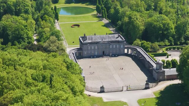 ch&acirc;teau seneffe visitors walking near main structure surrounding areas add depth to scenic composition inviting right left pans aerial drone of de 