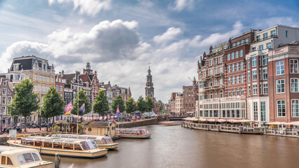 Panoramic timelapse hyperlapse of Amsterdam city center featuring Amstel River, waterfront and Munttoren tower. Netherlands