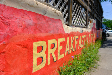 A breakfast sign painted on a cafe in the bright sunshine