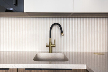 kitchen faucet on a stylish metal sink