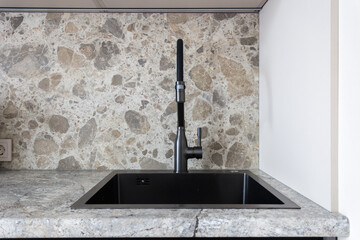 kitchen faucet on a stylish metal sink
