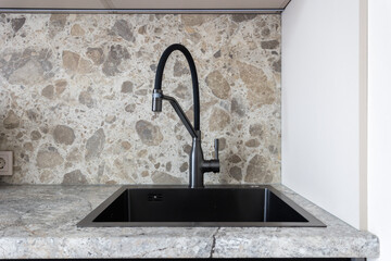 kitchen faucet on a stylish metal sink