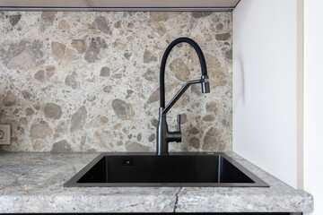 kitchen faucet on a stylish metal sink